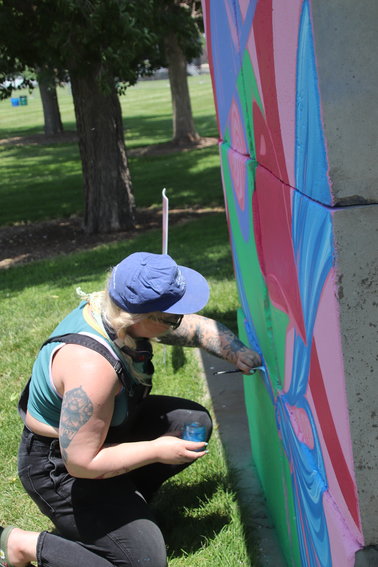 Babe Walls member Kaitlin Ziesmer paints her mural.